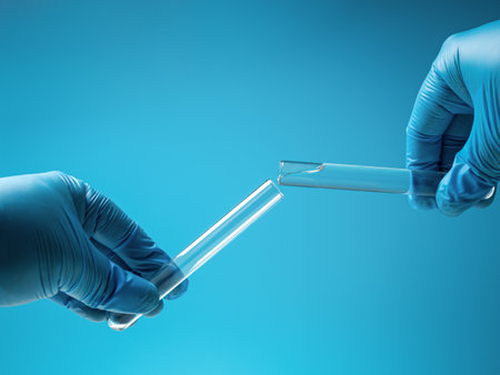 Transfuse liquid from one tube into laboratory test glass tube, nobody. closeup. blue toneの写真素材