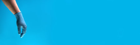 Man in blue latex gloves, closeup. Long bannerの写真素材