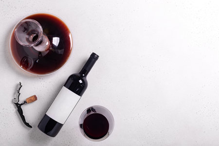 Decanter, glass and bottle with red wine on white background. Flat layの写真素材