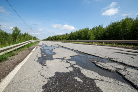 Potholes on bad asphalt road. Closeup. Nobodyの写真素材