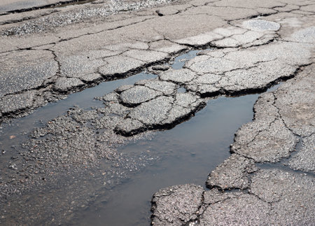Potholes on bad asphalt road. Closeup. Nobodyの写真素材