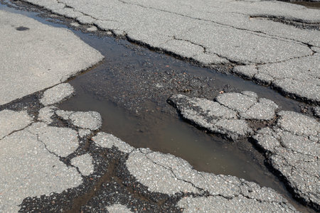Potholes on bad asphalt road. Closeup. Nobodyの写真素材