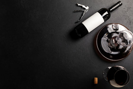 Decanter, glass and bottle with red wine on black background. Flat layの写真素材