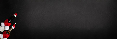 Glasses and bottles with red and white wine on black background. Flat lay. Long bannerの写真素材