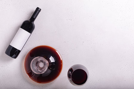 Decanter, glass and bottle with red wine on white background. Flat layの写真素材