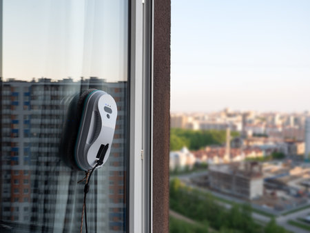 Vacuum cleaner washing windows. Home appliance and technology concept. Closeupの写真素材