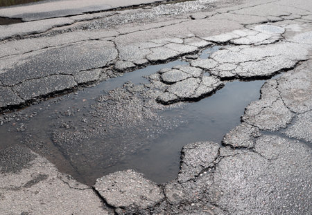 Potholes on bad asphalt road. Closeup. Nobodyの写真素材