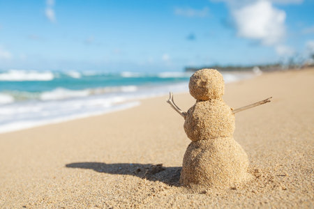 Caribbean Christmas Snowman made out of sand on sandy beach. Holiday vacation in hot countries concept. New Year travel greeting card with copy space.の写真素材