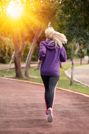 Woman training and jogging in summer park. Healthy lifestyle and sport conceptの写真素材