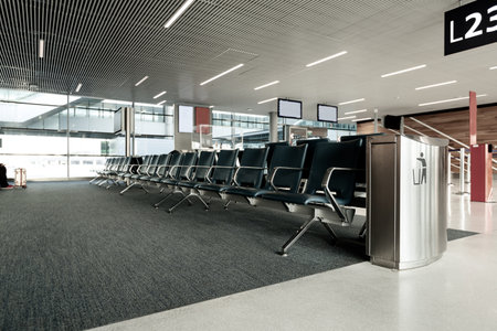 Empty airport terminal with seats in waiting area, nobodyの写真素材