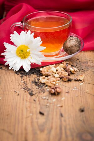mug of tea with lemon and nuts on a wooden stand. I love autumn. I love tea.の写真素材