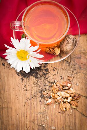 mug of tea with lemon and nuts on a wooden stand. I love autumn. I love tea.の写真素材