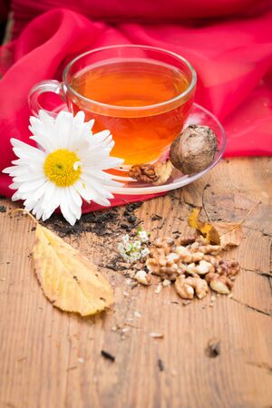 mug of tea with lemon and nuts on a wooden stand. I love autumn. I love tea.の写真素材