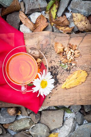 mug of tea with lemon and nuts on a wooden stand. I love autumn. I love tea.の写真素材