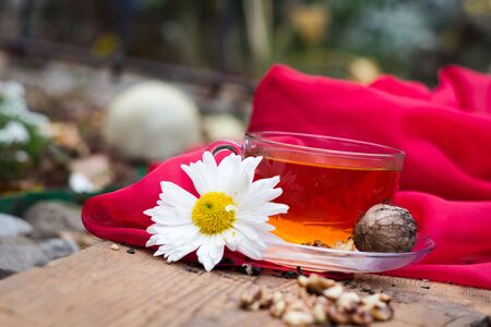 mug of tea with lemon and nuts on a wooden stand. I love autumn. I love tea.の写真素材