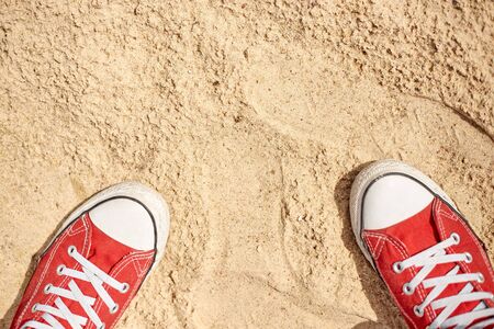 Sneakers are on the sandの写真素材