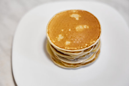 A stack of pancakes is on a white plate, Pancakes on a white plate top view, Pancakes on a white...