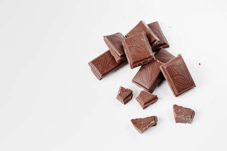 Milk chocolate pieces isolated on white background from top view, close up a chocolate bar isolated on white backgroundの写真素材