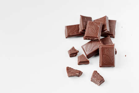 Milk chocolate pieces isolated on white background from top view, close up a chocolate bar isolated on white backgroundの写真素材