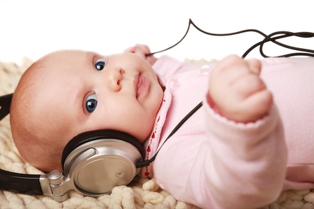 beautiful little girl listening to the musicの写真素材