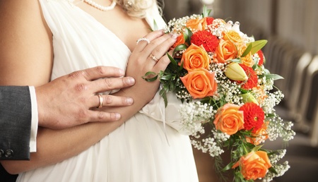 hands with rings and bouquetの写真素材