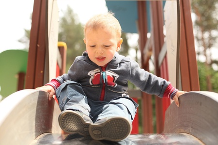 little kid getting ready to slideの写真素材