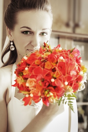beautiful bride with red bouquetの写真素材