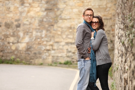 young woman holding her boyfriend with scarfの写真素材