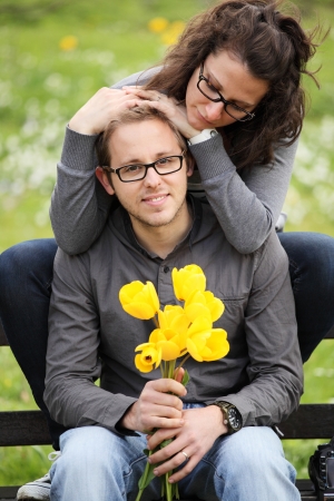 couple sitting on a bench in the parkの写真素材