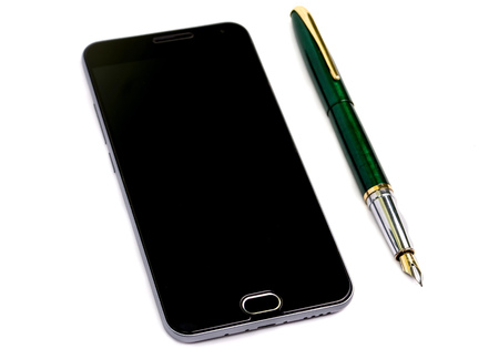 Workplace. Phone, tablet and notepad on the tableの写真素材