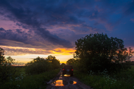 Novgorod oblast, Russia, August 03, 2015, Jeep Wrangler on a rural road in the Novgorod region, the Jeep Wrangler is a compact four wheel drive off road and sport utility vehicleのeditorial素材