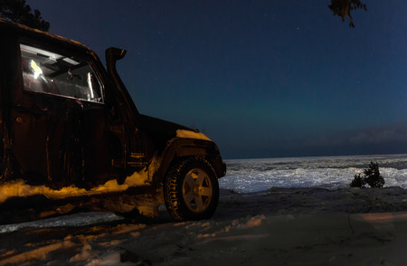 Leningrad Oblast, The Road Of Life, Russia, November 11, 2016. Jeep Wrangler in the background of the Northern lights, the Jeep Wrangler is a compact four wheel drive off road and sport utility vehicleのeditorial素材