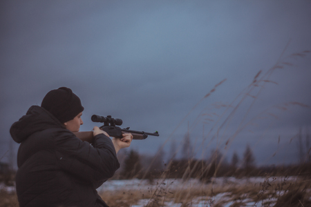 a hunter with a gun in autumn field, Russia