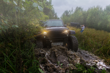 09/09/2017. Leningrad region. Russia. Jeep Wrangler with forest road in the Leningrad region. Wrangler is a compact SUV manufactured by Chryslerのeditorial素材