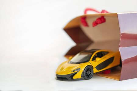 Ð¡ar in a gift bag on a white backgroundの写真素材