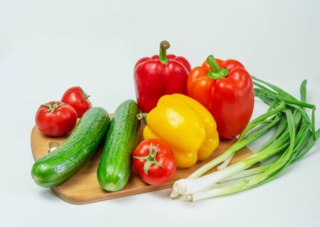 Delicious cuisine. Fresh vegetables on a wooden board, ready for slicing lettuceの写真素材