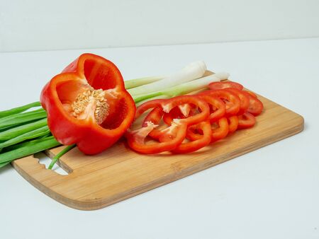 Delicious cuisine. Fresh vegetables on a wooden board, ready for slicing lettuceの写真素材