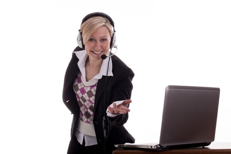Secretary with laptop and headset points to viewerの写真素材