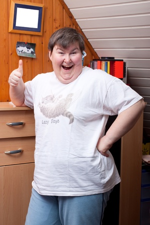 mentaly disabled woman with thumb up points to viewerの写真素材