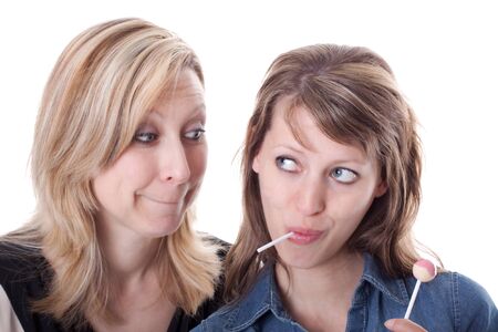 a blond woman wants the sweets from the brunette womanの写真素材