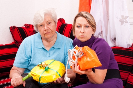 old and young woman are getting improper giftsの写真素材