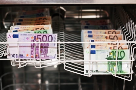 money laundering in the dishwasher with banknotesの写真素材