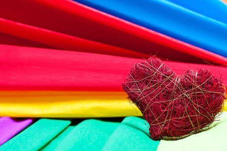 colorful background with crepe paper and a heartの写真素材
