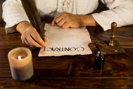 medieval man writes a contractの写真素材