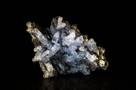 Aquamarine crystal with black tourmaline in front of black