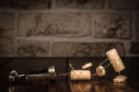 Concept escape from a corkscrew with wine cork figuresの写真素材
