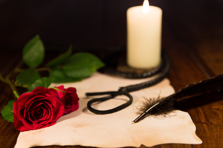 letter, whip, candle and roseの写真素材