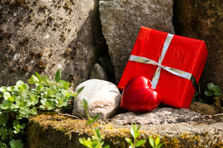 a close up of a rockery with a red heart and a giftの写真素材