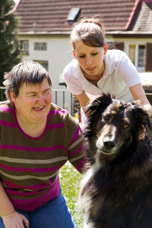 disabled woman is making a animal-assisted therapyの写真素材