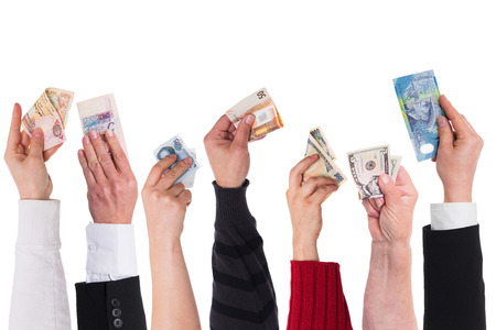 different currencies holding by different handsの写真素材